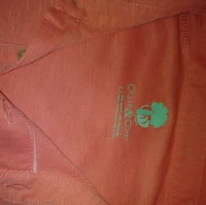 Salmon color mens collared shirt.